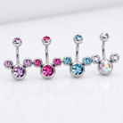 Four silver-toned navel barbell piercings with round faceted gemstones in pink, light blue, and iridescent colors, arranged on a clean white background.