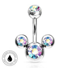 A silver-toned curved barbell belly button ring with three ball end settings, each holding an iridescent rainbow crystal. A circular badge in the lower-left corner reads 'SKINSAFE WATERPROOF' with a droplet icon.