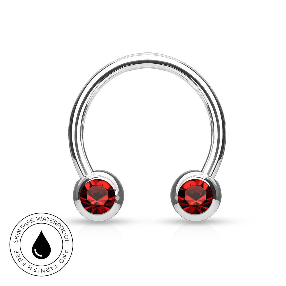 A silver-toned curved barbell piercing stud with two round red gemstone accents, shown on a white background with a small circular 'skin-safe waterproof and tarnish free' badge in the lower left.