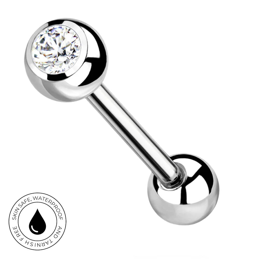 A polished stainless steel barbell piercing stud with a clear round gemstone on one end, shown on a white background with a circular 'Skin Safe Waterproof' badge in the lower-left corner.