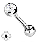 A polished stainless steel barbell piercing stud with a clear round gemstone on one end, shown on a white background with a circular 'Skin Safe Waterproof' badge in the lower-left corner.