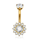 Gold-plated navel piercing barbell with a flower-shaped cluster of clear cubic zirconia stones, featuring a circular inset showing the threaded end detail.
