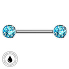 A silver-toned barbell piercing jewelry piece with two round bezel-set light blue gemstones, shown on a plain white background with a circular 'skin-safe waterproof' badge in the lower-left corner.