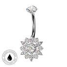 A curved barbell belly button ring with a snowflake-shaped cluster of clear crystals on a white background, featuring a circular 'Skin Safe Waterproof' badge in the bottom-left corner.