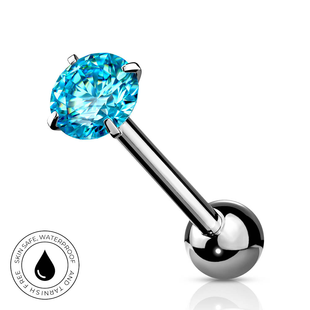 A silver-toned labret piercing barbell with a round brilliant-cut light blue gemstone and a polished ball end, shown on a white background with a small circular 'skin-safe waterproof' badge in the lower left.