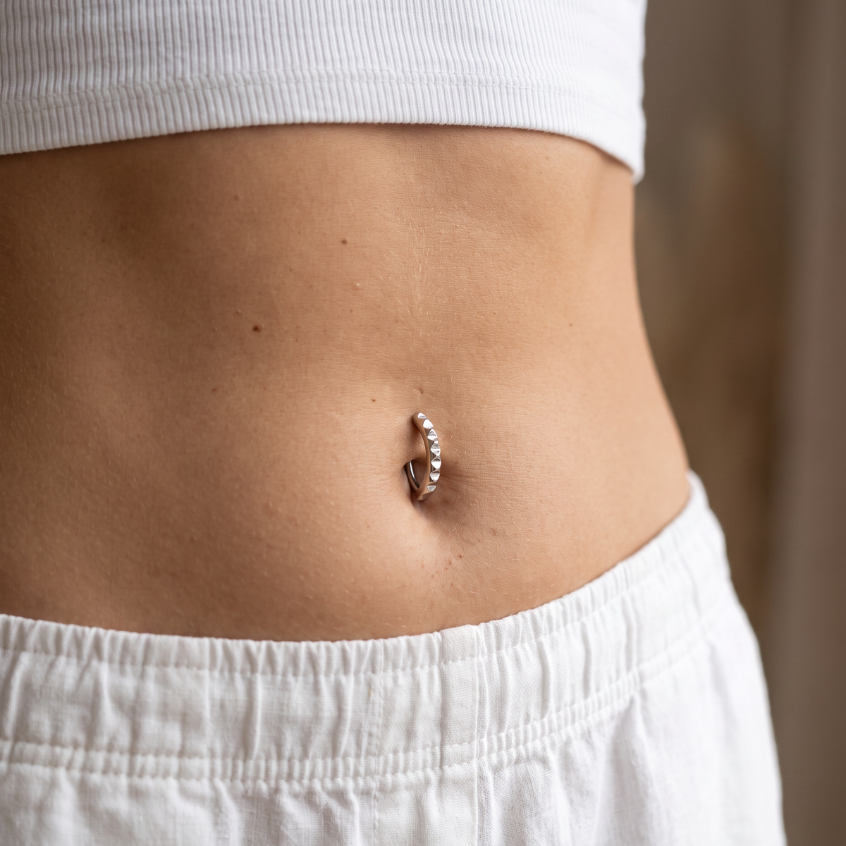 14 Gauge Studded Hinged Belly Button Ring worn by female model