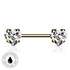A gold-plated barbell nose ring with two heart-shaped clear gemstones, shown on a white background with a small circular 'skin-safe waterproof' badge in the lower-left corner.