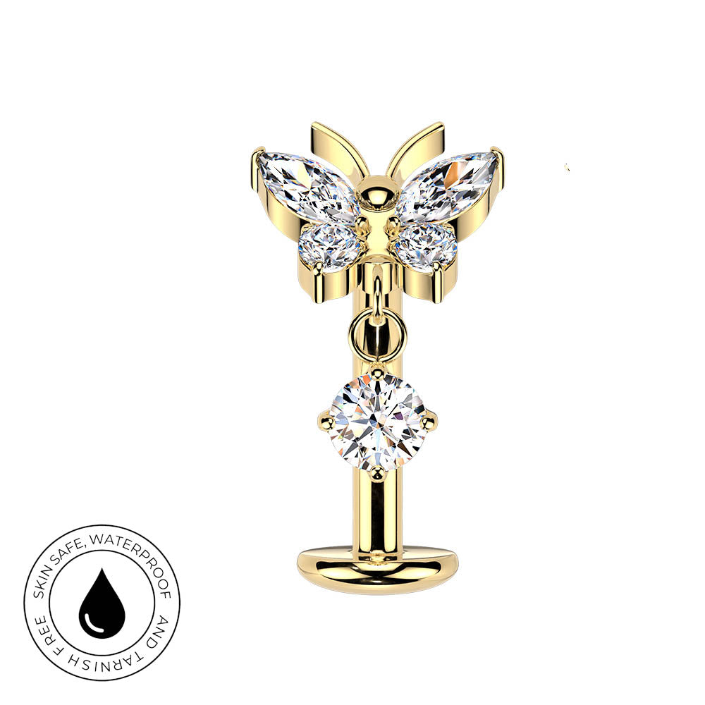 Gold butterfly-shaped body jewelry with clear gemstones, shown on a white background with a circular skin-safe waterproof badge in the lower-left corner.