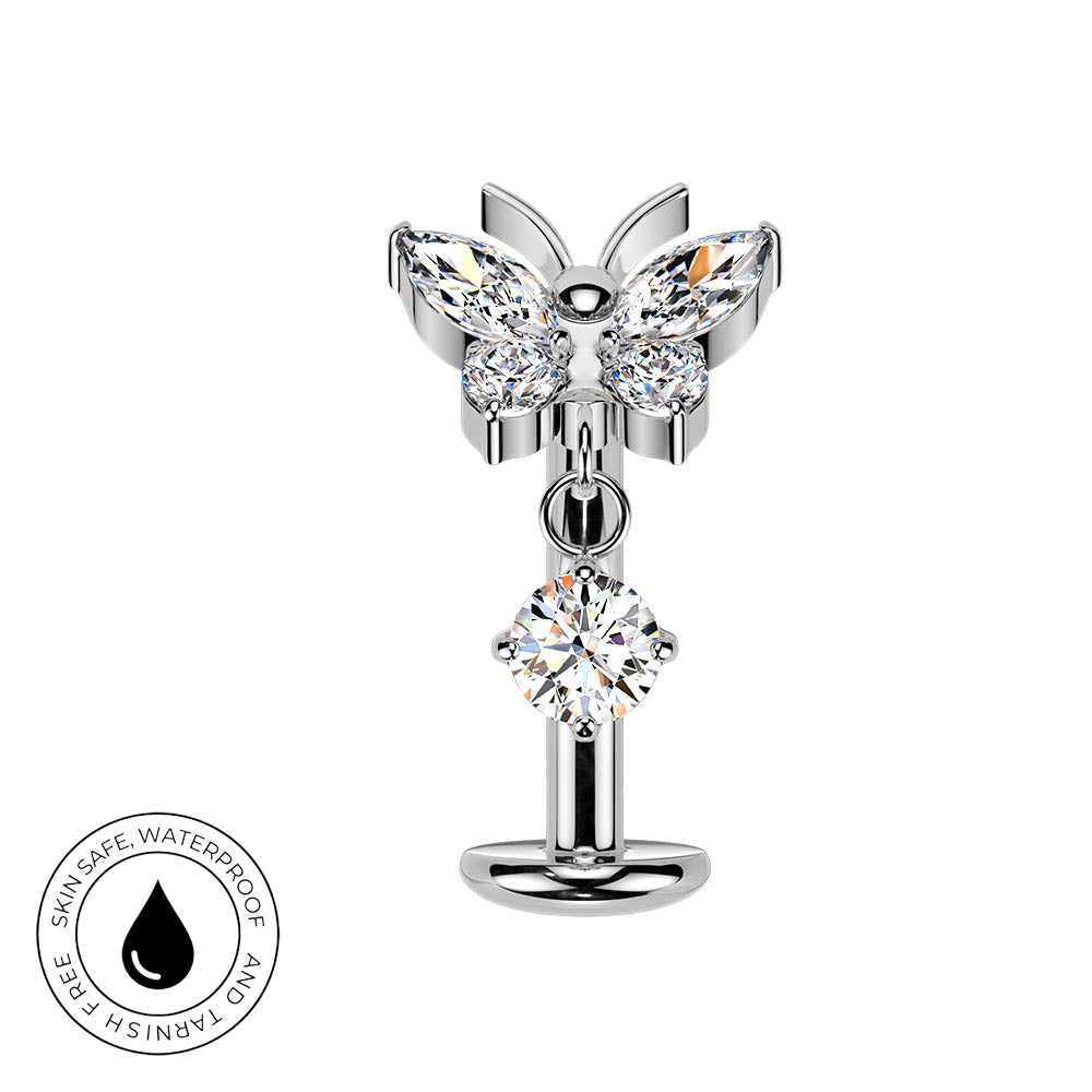 A silver butterfly-shaped body jewelry piece with clear faceted gemstones, shown on a plain white background with a circular 'skin-safe waterproof' badge in the lower-left corner.