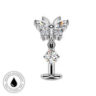 A silver butterfly-shaped body jewelry piece with clear faceted gemstones, shown on a plain white background with a circular 'skin-safe waterproof' badge in the lower-left corner.