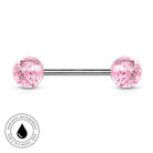A pink glitter barbell piercing stud with a silver-toned metal bar, shown on a white background with a circular 'Skin Safe Waterproof' badge in the bottom-left corner.
