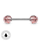A silver-toned barbell piercing jewelry piece with two round end beads covered in red, pink, and black glitter, shown on a white background with a circular 'Skin Safe Waterproof' badge in the bottom-left corner.