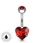 A silver-toned navel barbell piercing with a faceted red heart-shaped crystal and a smaller red crystal at the top, shown on a white background with a circular 'Skin Safe Waterproof' badge in the lower left.