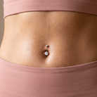 14 Gauge Titanium Double Crystal Belly Bar worn by female gym model