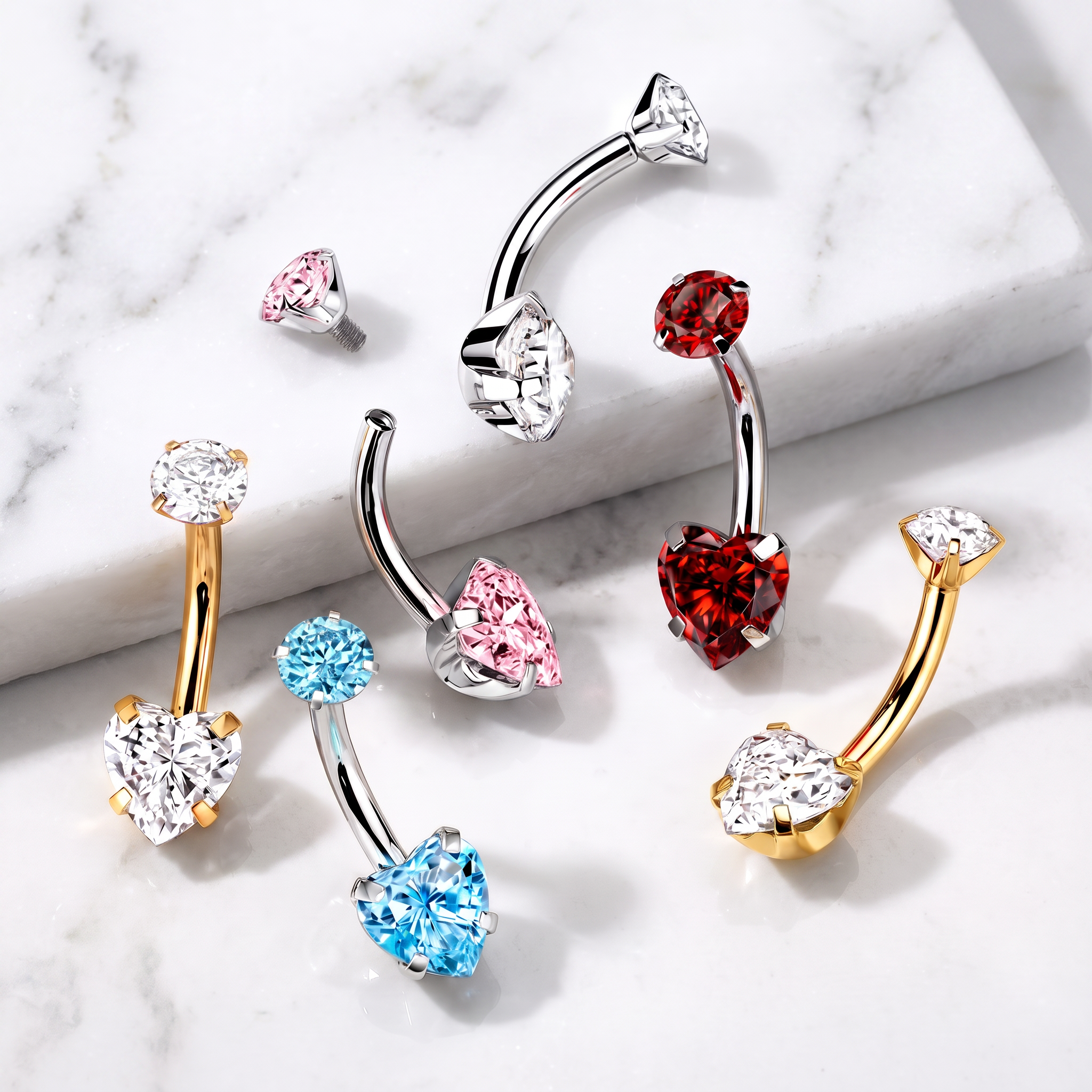 Six curved barbell body jewelry piercings with heart-shaped gemstones in silver, gold, pink, red, and blue, arranged on a white marble surface.