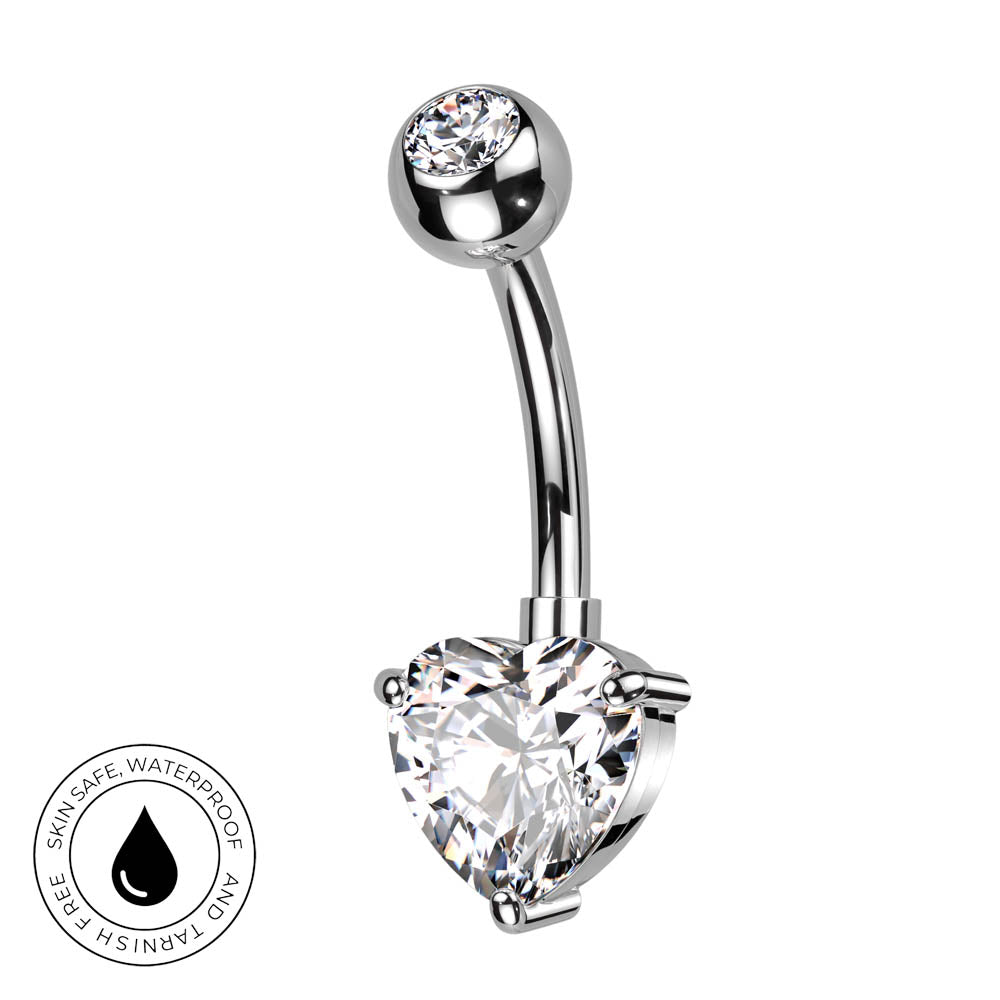A silver-toned curved barbell belly button ring with a large heart-shaped clear crystal and a smaller round clear crystal at the top. A circular badge in the lower-left corner reads 'SKINSAFE WATERPROOF' with a droplet icon.