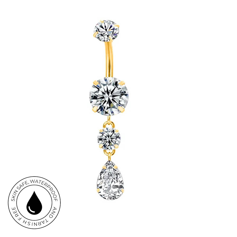 Gold-plated curved navel barbell with three dangling clear cubic zirconia stones, shown on a white background with a circular skin-safe waterproof badge in the lower-left corner.