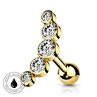 Gold-plated curved barbell piercing stud with four clear round-cut cubic zirconia stones, shown on a white background with a circular 'Skin Safe Waterproof' badge in the lower-left corner.