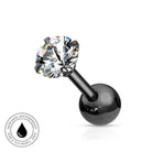 Black ball labret piercing stud with a clear faceted gemstone in a prong setting, shown on a white background with a circular skin-safe waterproof badge in the lower-left corner.
