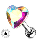 A heart-shaped acrylic or glass body jewelry piece with a faceted, rainbow-reflective surface, attached to a polished silver barbell. A circular badge in the lower-left corner reads 'SKINSAFE WATERPROOF AND TARIASH FREE'.