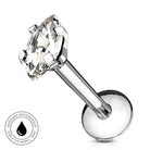 A silver-toned labret piercing stud with a large clear marquise-cut gemstone, shown on a white background with a circular 'Skin Safe Waterproof' badge in the lower-left corner.