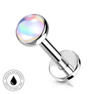 A round barbell piercing stud with a polished silver-tone metal post and a domed, iridescent shell-like top that shifts between pastel colors. A small circular badge in the lower-left corner reads 'SKINSAFE WATERPROOF' with a water droplet icon.