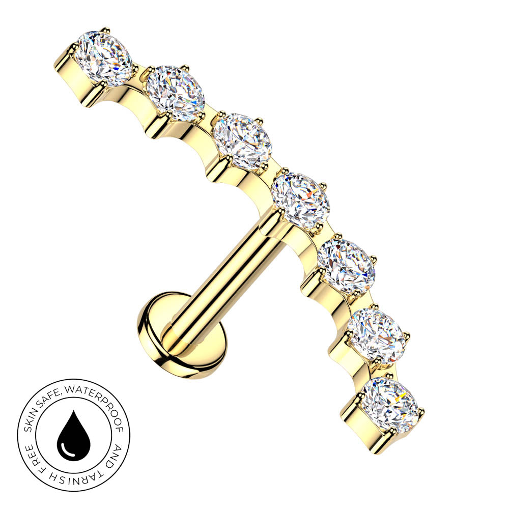 Gold barbell nipple stud with seven round-cut clear gemstones, shown on a white background with a circular 'Skin Safe Waterproof' badge in the lower-left corner.