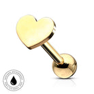 A gold-plated heart-shaped labret piercing stud with a polished ball back, shown on a clean white background with a small circular 'Skin Safe Waterproof' badge in the bottom-left corner.