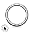 A polished stainless steel circular ring with a black inner lining, shown on a white background with a small circular 'SkinSafe Waterproof' badge in the lower-left corner.