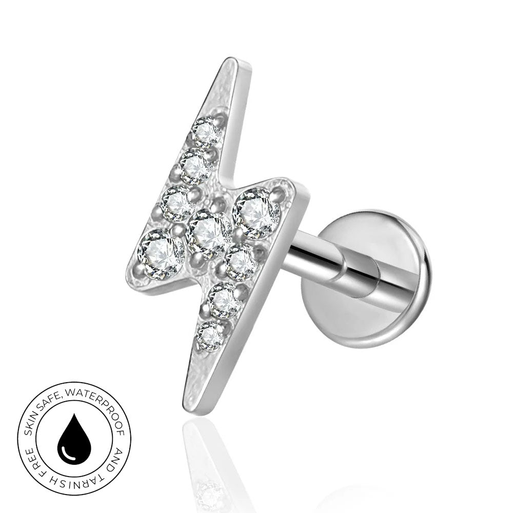 A silver lightning bolt stud earring with clear gemstones, shown on a white background with a circular 'Skin Safe Waterproof' badge in the lower-left corner.