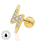 Gold lightning bolt stud earring with clear round-cut gemstones, shown on a white background with a circular 'skin-safe waterproof' badge in the lower-left corner.