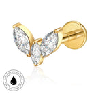 Gold butterfly stud earrings with marquise-cut clear gemstones, shown on a white background with a circular 'skin-safe waterproof' badge in the lower left.