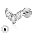 A pair of silver-tone butterfly stud earrings with marquise-cut clear gemstones, shown on a white background with a small circular 'skin-safe waterproof' badge in the lower left corner.