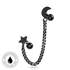Black metal ear piercing jewelry featuring a curved chain with a star charm and a crescent moon stud, shown on a white background with a circular skin-safe waterproof badge.
