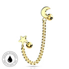 Gold-toned ear piercing jewelry featuring a curved chain with a star charm and a crescent moon charm, shown on a white background with a circular skin-safe waterproof badge.