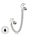 Sterling silver curved barbell piercing jewelry featuring a star charm and a short curb chain leading to a crescent moon charm, displayed on a clean white background with a circular skin-safe waterproof badge in the lower-left corner.