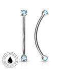 Two silver-toned labret and curved barbell piercings with light blue gemstones, shown on a white background with a circular 'Skin Safe Waterproof' badge in the lower left.