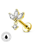 A gold flower-shaped labret piercing stud with clear marquise and round gemstones, shown on a white background with a circular skin-safe waterproof badge in the lower-left corner.