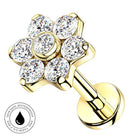 Gold flower-shaped cartilage piercing stud with six clear round-cut cubic zirconia stones, shown on a white background with a circular 'Skin Safe Waterproof' badge in the lower-left corner.