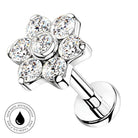A silver-toned flower-shaped piercing stud with six clear faceted gemstones, shown on a white background with a circular 'SkinSafe Waterproof' badge in the lower-left corner.