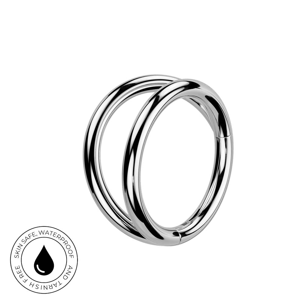A polished silver-toned double hoop ring shown on a plain white background, with a circular skin-safe waterproof badge in the lower-left corner.
