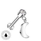 A silver-toned barbell piercing stud with a clear faceted gemstone on the top ball and a dangling crescent moon charm, shown on a plain white background with a small circular 'skin-safe waterproof' badge in the lower left.