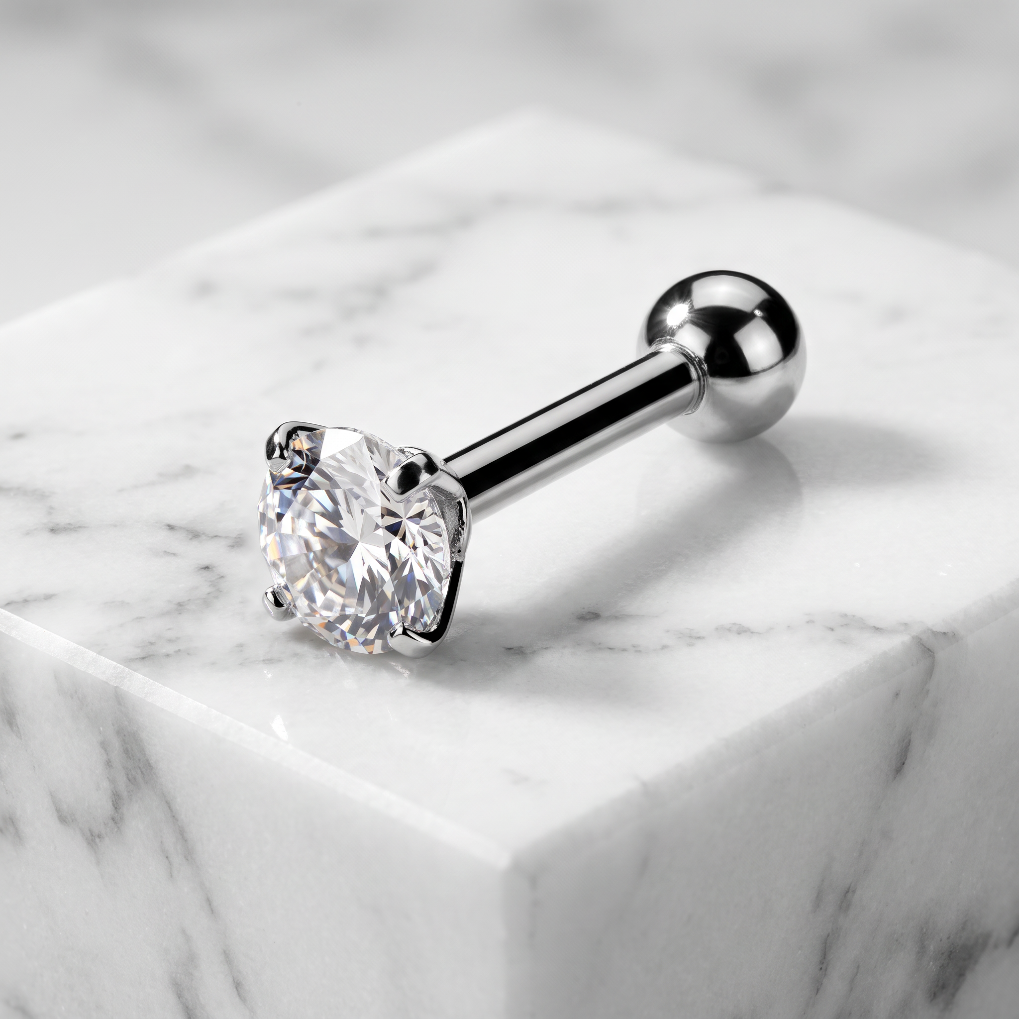 A silver-toned labret piercing stud with a large clear round-cut gemstone in a four-prong setting, displayed on a white marble block.
