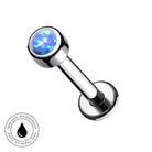 A chrome-plated labret piercing barbell with a round bezel-set blue opal stone, shown on a plain white background with a circular 'Skin Safe Waterproof' badge in the bottom-left corner.