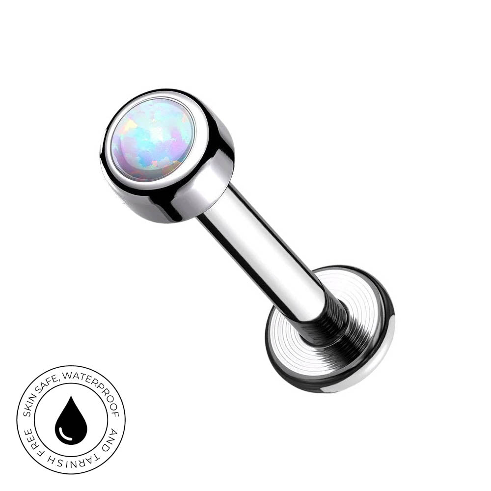 A chrome-plated labret piercing barbell with a round iridescent opal gemstone in the top ball, shown on a plain white background with a circular 'Skin Safe Waterproof' badge in the bottom-left corner.