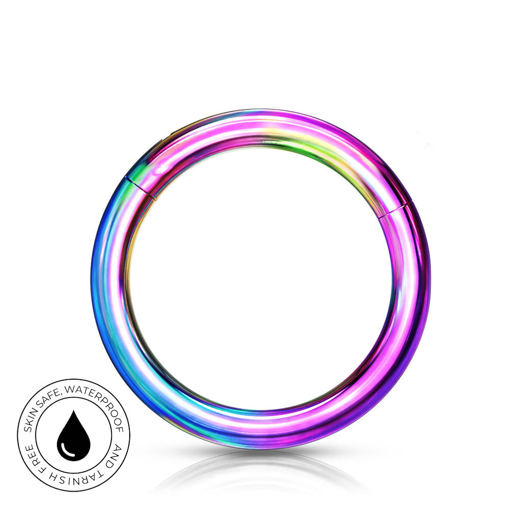A metallic circular ring with a rainbow iridescent finish, shown on a white background with a small circular 'skin-safe waterproof' badge in the lower left.