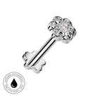 A silver flower-shaped labret piercing stud with a clear central gemstone, shown on a white background with a circular 'Skin Safe Waterproof' badge in the lower-left corner.