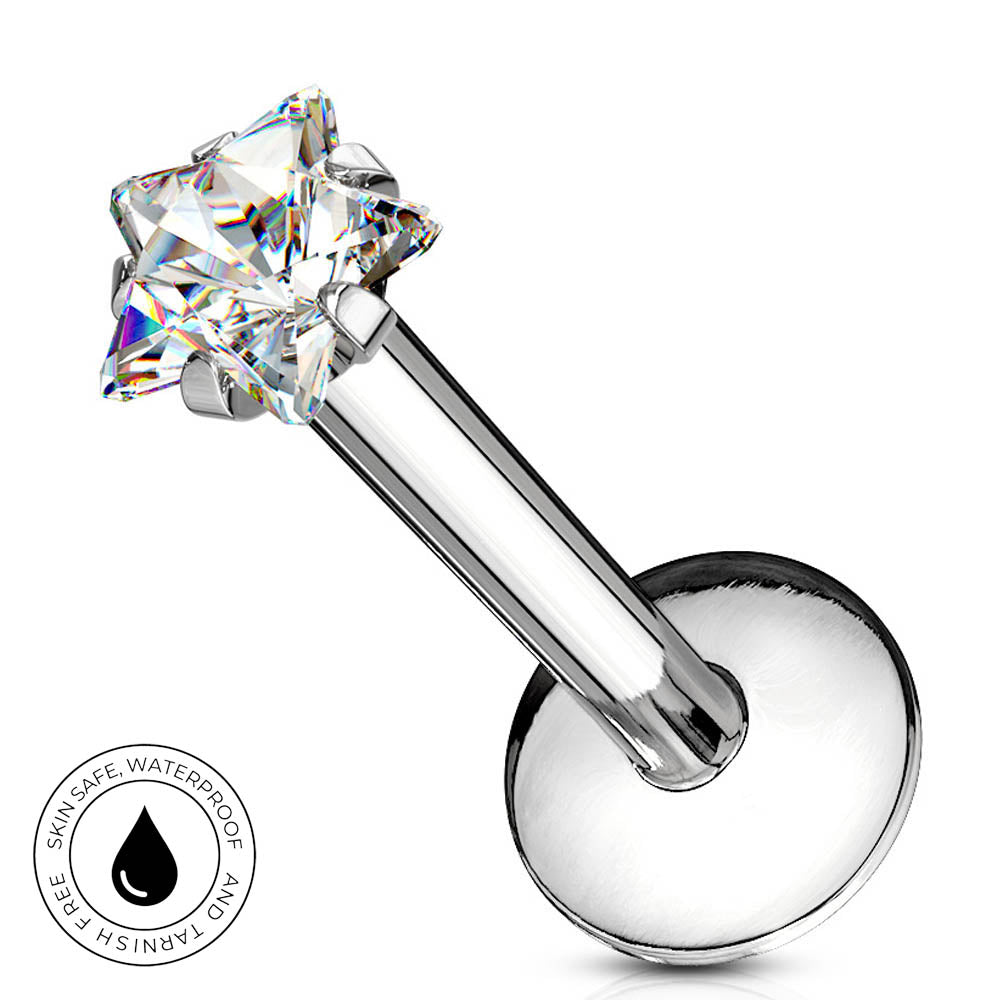 A silver-toned labret piercing barbell with a clear, multi-faceted star-shaped gemstone. A circular badge in the bottom-left corner highlights the product's 'Skin Safe Waterproof' feature.