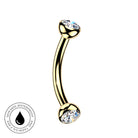 Gold curved barbell piercing jewelry with clear rhinestone ends, shown on a white background with a circular skin-safe waterproof badge in the lower left corner.