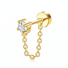 A gold-colored ear cuff stud earring featuring a round clear gemstone in a prong setting and a delicate dangling link chain, shown on a clean white background.